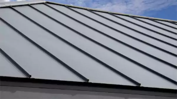 Standing seam metal roof with sleek vertical panels on a modern residential building