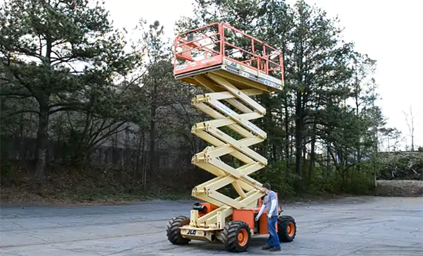 A worker operating a scissor lift