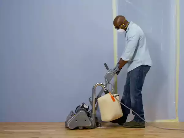 A worker sanding the timber floor