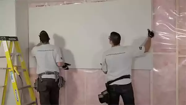 Attaching drywall after the concrete has cured completely for the final touch