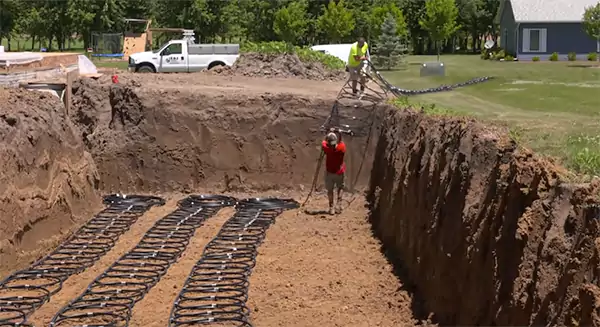 Workers installing the horizontal loop in a trench