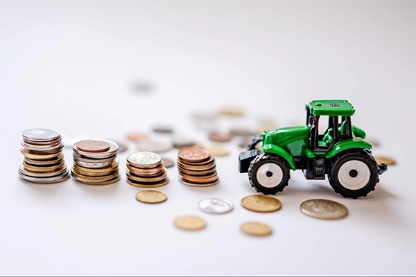 Toy Tractor Near Coins