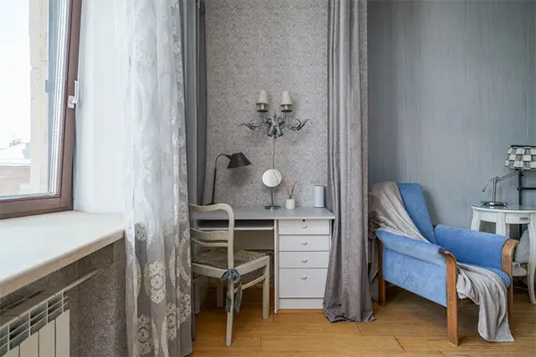 Elegant interior featuring a blue armchair desk and soft curtains perfect for home decor inspiration
