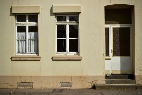 two outside windows and a door of a house