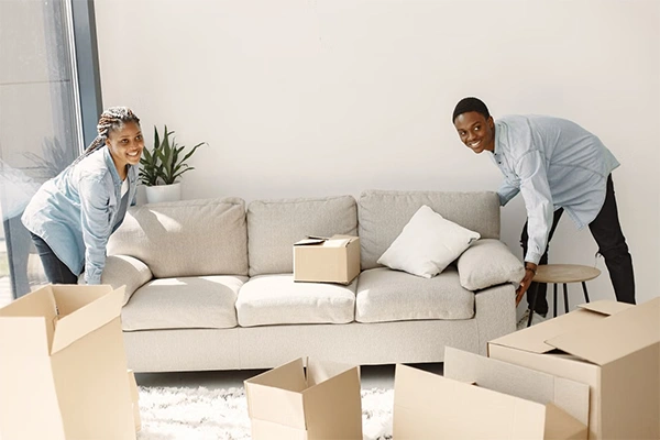 two people fixing the sofa at their home