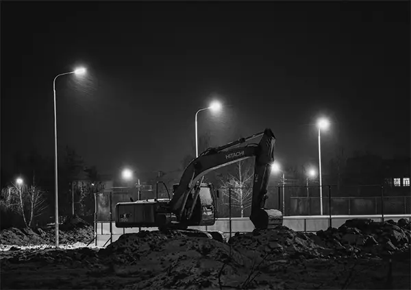 a fully lit up construction site area with pole lights