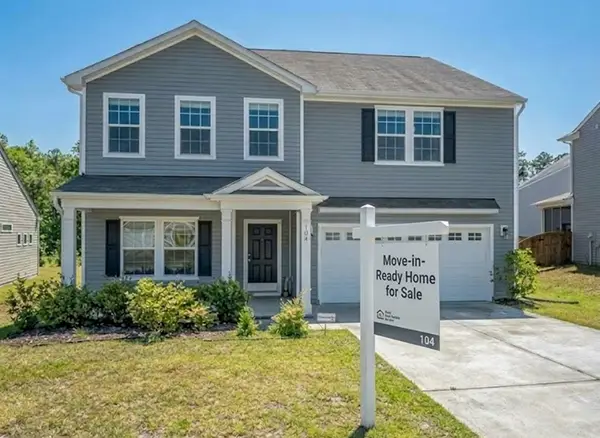 a house in beautiful open space with a board of Move in Ready Home for Sale written on it
